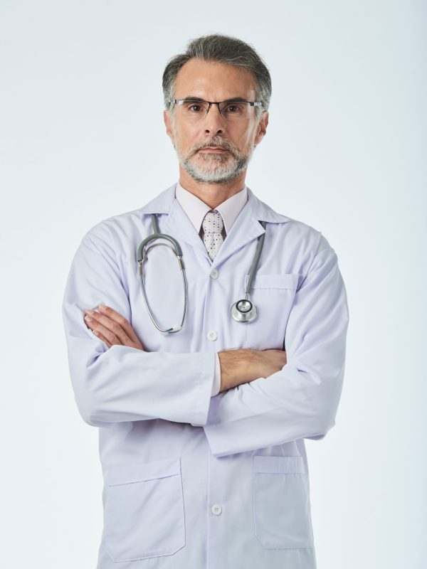 Portrait of confident doctor standing with his arms folded